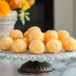 A decorative platter of pumpkin cream cheese balls arranged with a festive fall background